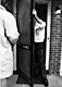 February 18, 1970: CID Investigator Bill Ivory stands with an arm on the utility room screen door of 544 Castle Drive as fingerprint examiner Hilyard Medlin observes