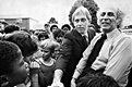 August 3, 1979: After the jury's visit to 544 Castle Drive, Bernard Segal grins broadly as Jeffrey MacDonald talks, laughs and shakes hands with spectators.<br><br>In the words of Joe McGinniss in <em>Fatal Vision,</em> MacDonald "was surrounded by a throng of excited housewives and smiling children who called out words of encouragement. Some of the children even rushed forward to shake his hand... It was nice, he said...It was the first time in nine and a half years that he had made physical contact with a child on Castle Drive...He appreciated such signs of support. The children waved at him as he departed."