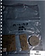 Photo #80, GPS, depicting plastic bag marked: 'PC-L1913 K2 PMS MPM', containing two double slide mailers, one single slide mailer, and one circular pill box all marked 'K2'