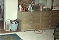Multi-colored jewelry box to left of phone on dresser in east bedroom (phone on dresser and Geneva Forge knife on floor circled by investigators)